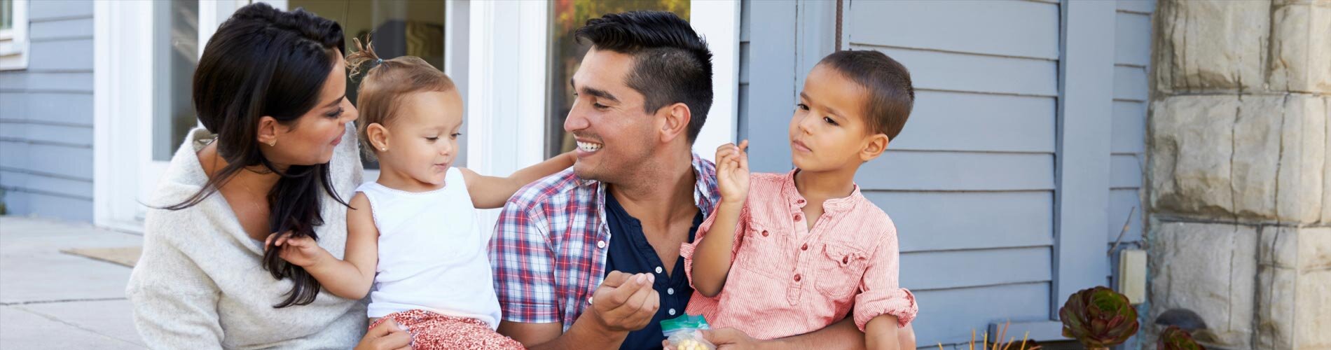 Family of 4 sitting on front porch
